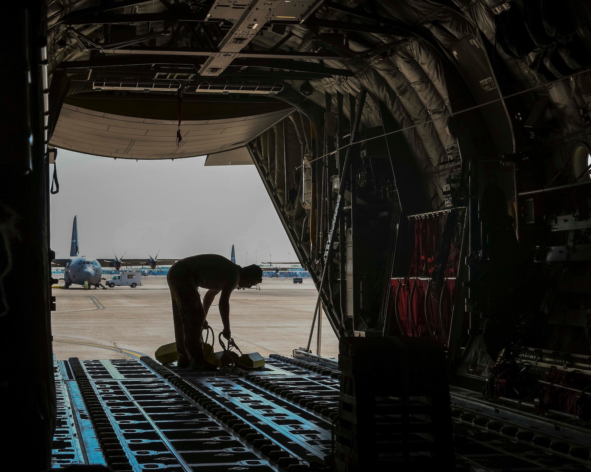 A U.S. Air Force loadmaster prepares a C-130J Super Hercules from Little Rock Air Force Base, Arkansas, for flight during a Joint Forcible Entry exercise near Las Vegas, June 6, 2020. More than 20 C-130Js and C-17 Globemaster IIIs flew in formation during the U.S. Air Force Weapons School’s Joint Forcible Entry exercise with numerous other aircraft from across the Air Force. (U.S. Air Force photo by Senior Airman Kristine M. Gruwell)