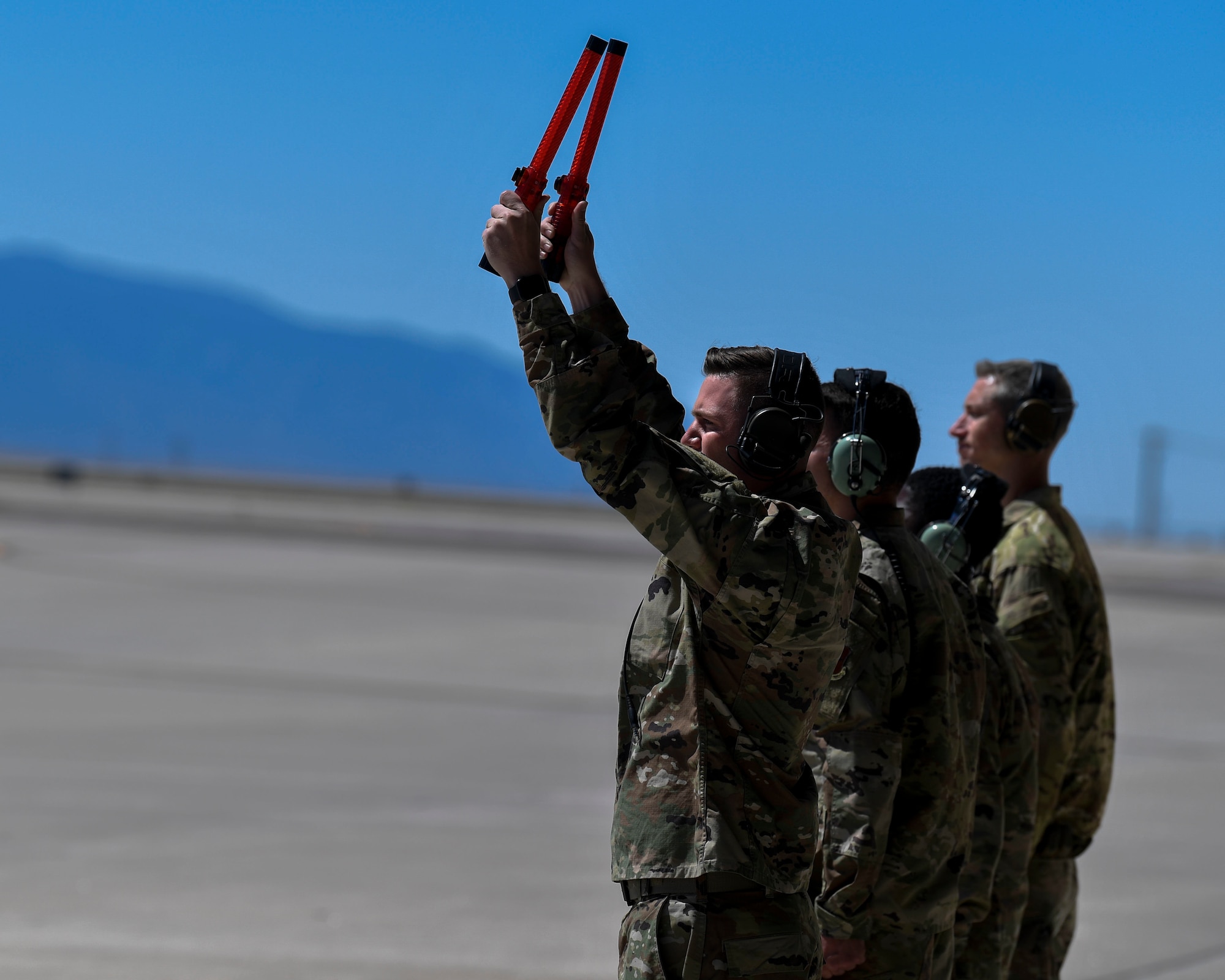 Airmen marshall an aircraft.