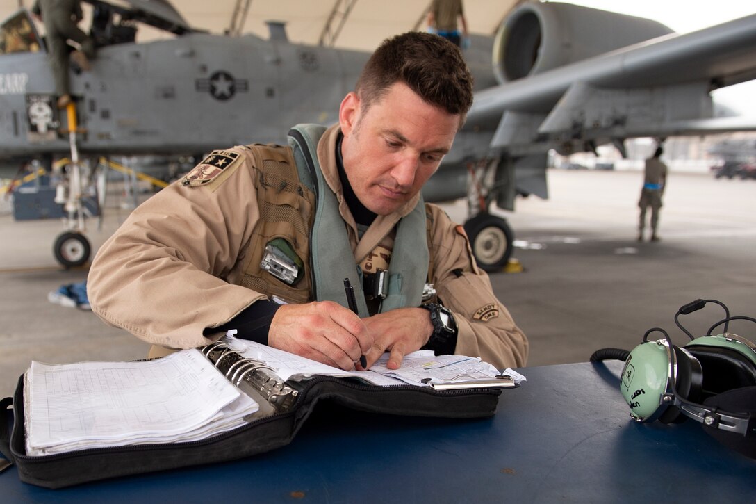 Lt. Col. Michael Sackenheim, 74th Expeditionary Fighter Squadron commander, completes a post-flight log after returning from a 5-month deployment June 10, 2020, at Moody Air Force Base, Georgia. Approximately 300 members assigned to the 74th EFS returned from deployment June 10-12. The 74th EFS, which consisted of personnel from the 23d Fighter Group and 23d Maintenance Group, were deployed as a part of Operation Freedom Sentinel. (U.S. Air Force photo by 2nd Lt. Kaylin P. Hankerson)