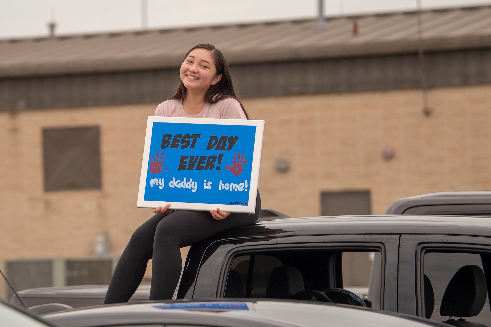 The daughter of an Airmen assigned to the 74th Expeditionary Fighter Squadron awaits his return from deployment June 10, 2020, at Moody Air Force Base, Georgia. Approximately 300 members assigned to the 74th EFS returned from deployment June 10-12. The 74th EFS, which consisted of personnel from the 23d Fighter Group and 23d Maintenance Group, were deployed as a part of Operation Freedom Sentinel. (U.S. Air Force photo by 2nd Lt. Kaylin P. Hankerson)