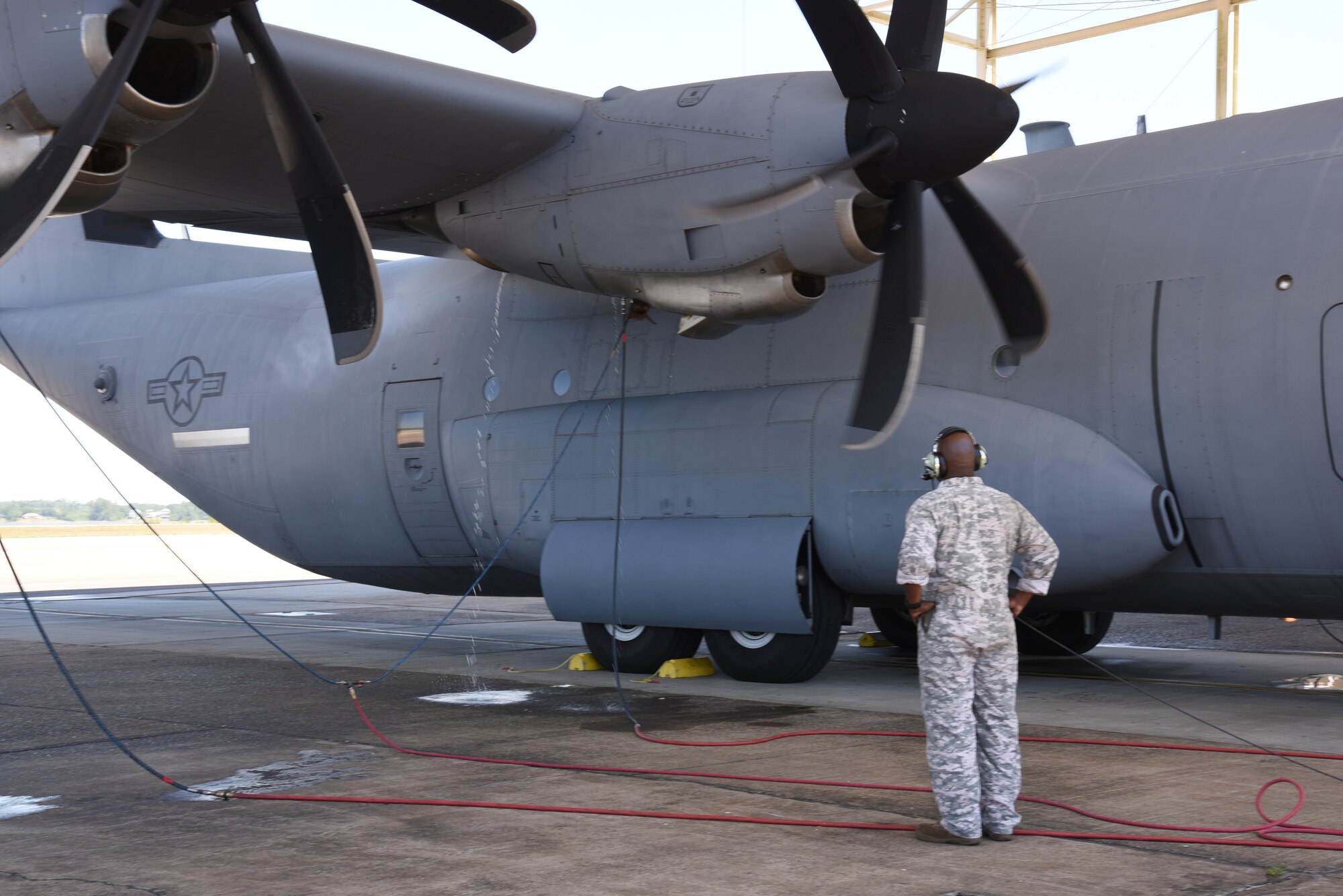Master Sgt. Donald Maloid, 403rd Maintenance Squadron propulsion technician, checks the water spray and mist that comes out of the engine compartment during the Engine Compressor Wash of an 815th Airlift Squadron C-130J Super Hercules to ensure the engine is clean before the aircraft goes for a "C" letter inspection in the Isochronal Dock at Keesler Air Force Base, Mississippi May 11, 2020. These inspections or letter checks can range from "A" five days basic check, "B" 18 days and more in depth, to "C" 22 days which is the most intrusive inspection; but are necessary to keep the aircraft maintained. (U.S. Air Force photo by Jessica L. Kendziorek)