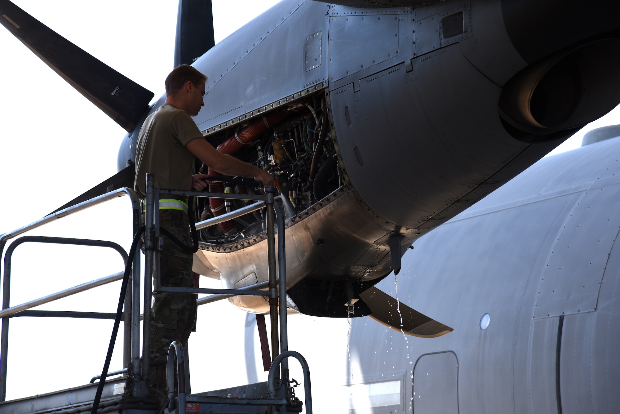 Senior Airman Jake Koltas, 403rd Maintenance Squadron propulsion technician, sprays the interior of the engine on an 815th Airlift Squadron C-130J Super Hercules removing excess dirt inside the engine compartment prior to completing an Engine Compressor Wash before the aircraft goes for a "C" letter inspection in the Isochronal Dock at Keesler Air Force Base, Mississippi May 11, 2020. These inspections or letter checks can range from "A" five days basic check, "B" 18 days and more in depth, to "C" 22 days which is the most intrusive inspection; but are necessary to keep the aircraft maintained. (U.S. Air Force photo by Jessica L. Kendziorek)