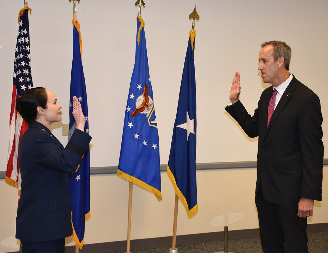 Brig. Gen. Alice W. Trevino, Air Force Installation Contracting Center commander, conducts a Senior Executive Service induction ceremony June 5 for Anthony ‘Tony’ Everidge, as he is named AFICC’s executive director. (U.S. Air Force photo/Thomas Lewis)