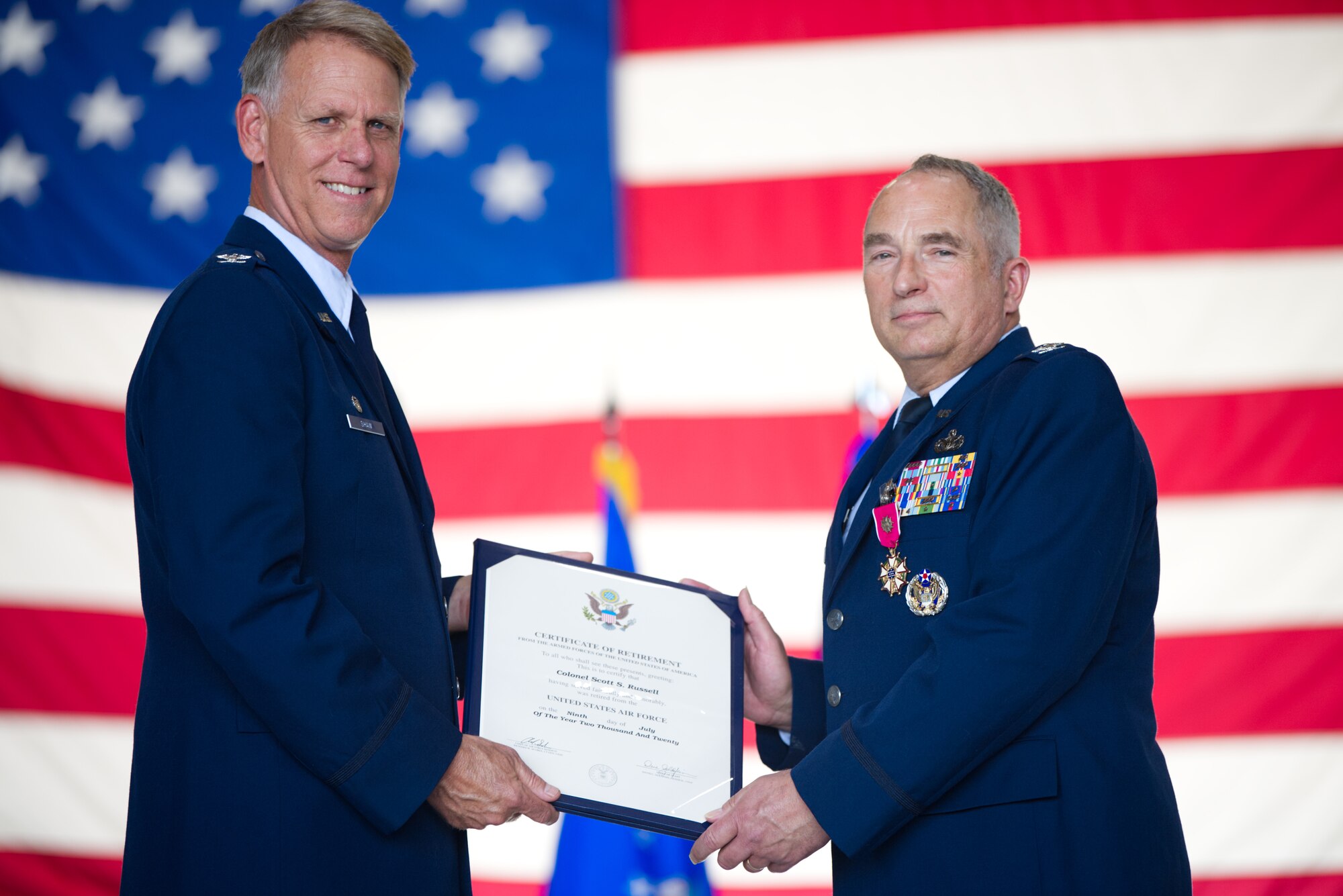 Col. Larry Shaw, 434th Air Refueling Wing Commander, presents Col. Scott Russell, 434th Mission Support Group commander, with his retirement certificate at Grissom Air Reserve Base, Ind., June 6, 2020. Russell bid farewell to Grissom during his retirement ceremony, completing his 41-year Air Force career. (U.S. Air Force photo / A1C Harrison Withrow)