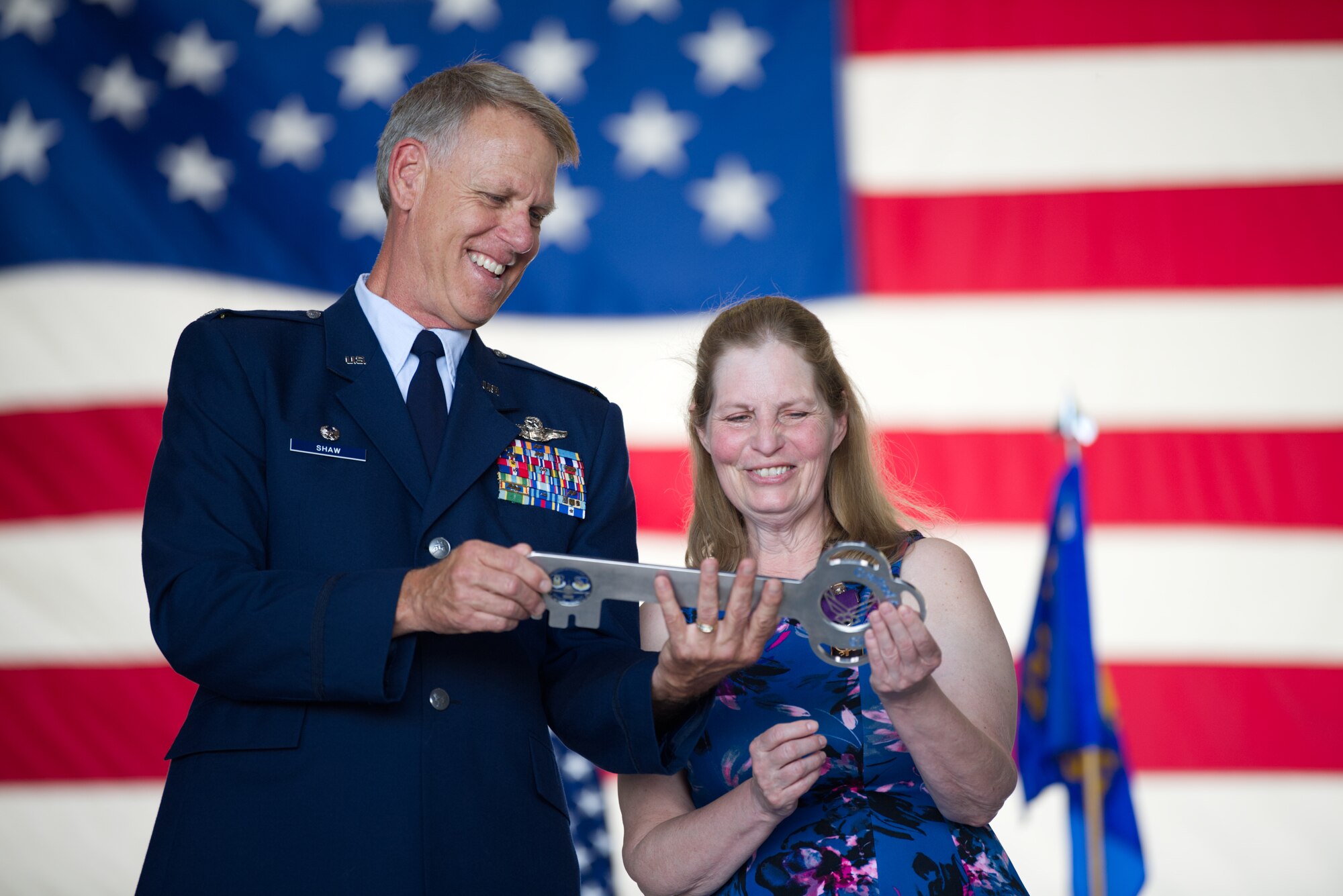 Col. Larry Shaw, 434th Air Refueling Wing commander, presents Terri Russell with a commemorative key engraved with her name at Grissom Air Reserve Base, Ind., June 6, 2020. Russell bid farewell to Grissom during his retirement ceremony, completing his 41-year Air Force career. (U.S. Air Force photo / A1C Harrison Withrow)