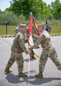 Lt. Col. Robert J. Kincaid recieves the command guideon from Brig. Gen. Russell Crane, Assistant Adjutant General, as he assumes command of the West Virginia National Guard's 111th Engineer Brigade in Eleanor, Saturday, June 13, 2020. The ceremony was held outdoors with family and friends in attendance. (U.S. Army National Guard photo by Edwin L. Wriston)