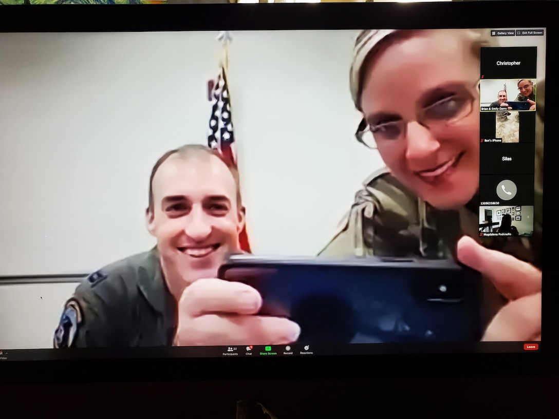 Maj. Emily Derry, 932nd Medical Squadron
Critical Care Flight commander, along with Capt. Tyler Relph, soon to be sworn-in to active duty,  attempt to take a photo of family and friends preparing to watch Relph's  virtual ceremony via Zoom, June 13, 2020, Scott Air Force Base, Illinois. (U.S. Air Force photo by Master Sgt. Christopher Parr)