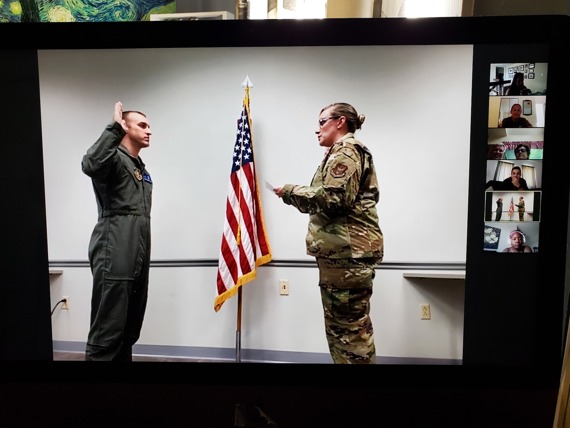 Capt. Tyler Relph, 932nd Medical Squadron critical care nurse, is sworn-in to active duty by Maj. Emily Derry, 932nd MDS Critical Care Flight commander, June 13, 2020 Scott Air Force Base, Illinois, as family and friends watch Relph's virtual ceremony via Zoom. (U.S. Air Force photo by Master Sgt. Christopher Parr)