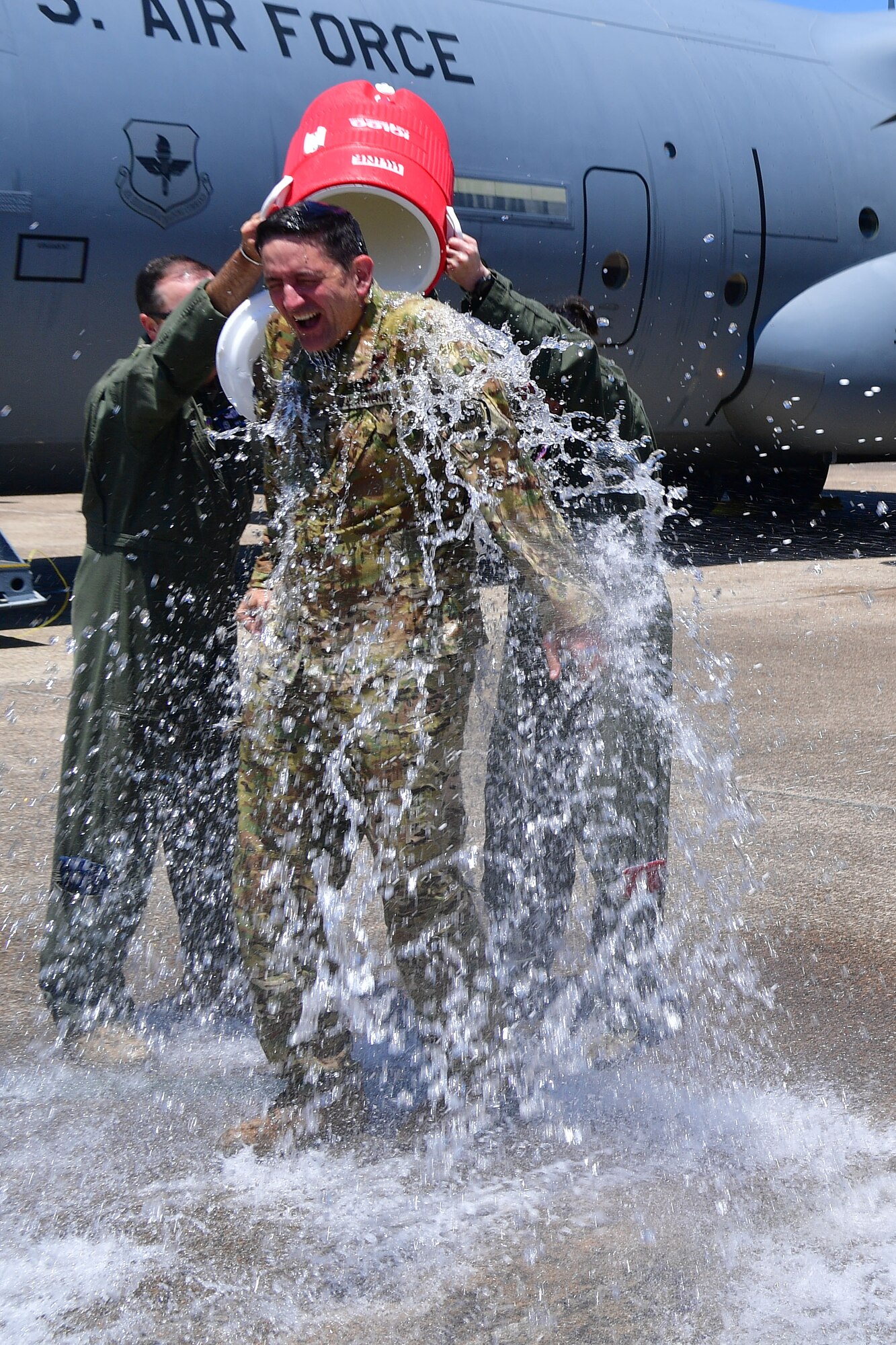 Col. Stephen Hodge, 314th Airlift Wing commander, gets a bucket of water dumped on him while exiting a C-130J Super Hercules upon completing his final flight as commander of the wing at Little Rock Air Force Base, Arkansas, June 12, 2020. Hodge is a command pilot with 3,500 hours of flight time, primarily in the C-130. He led missions during Operations Joint Endeavor, Southern Watch, Enduring Freedom and Iraqi Freedom. (U.S. Air Force photo by Airman 1st Class Aaron Irvin)