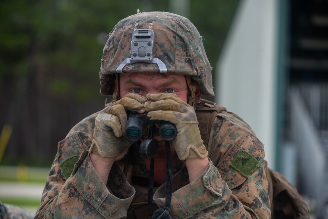 U.S. Marine Corps Lance Cpl. John Fleming, a rifleman with 2nd Light Armored Reconnaissance Battalion, 2nd Marine Division, observes a call for fire during the Isaak Competition at Camp Geiger, North Carolina, June 10, 2020. 2nd LAR hosts the annual competition to honor Cpl. Garreth Isaak, a LAR Marine who earned the Silver Star posthumously for actions during Operation Just Cause. (U.S. Marine Corps photo by Lance Cpl. Reine Whitaker)