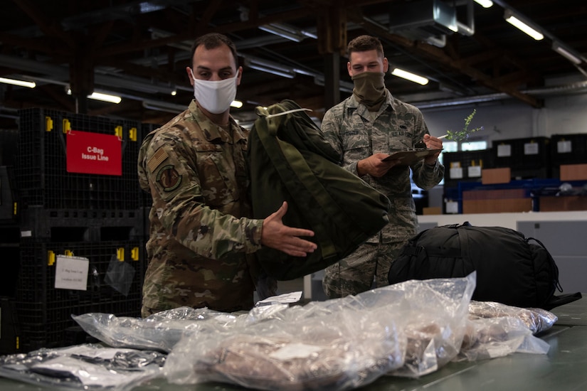 Airmen putting together a depolyment bag.