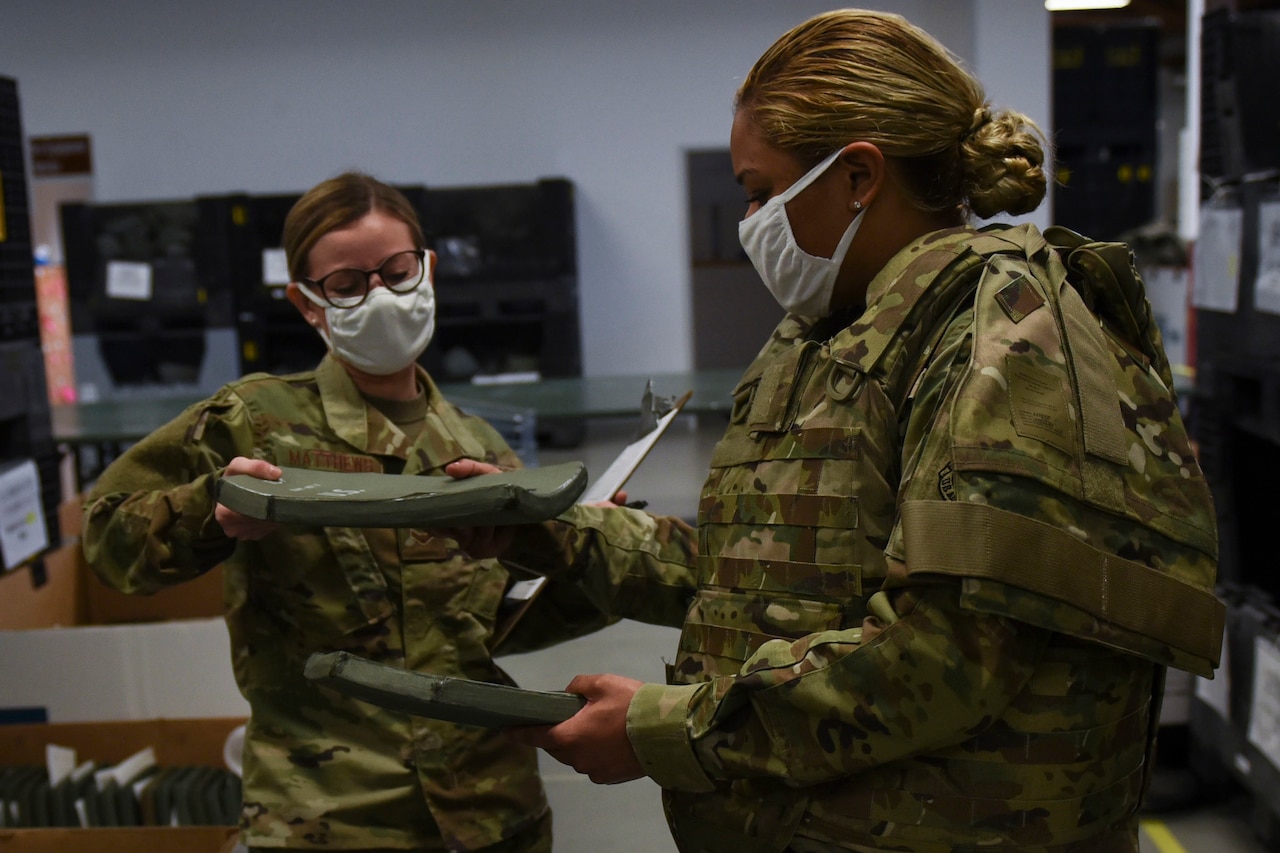 Airmen prepping a vest.