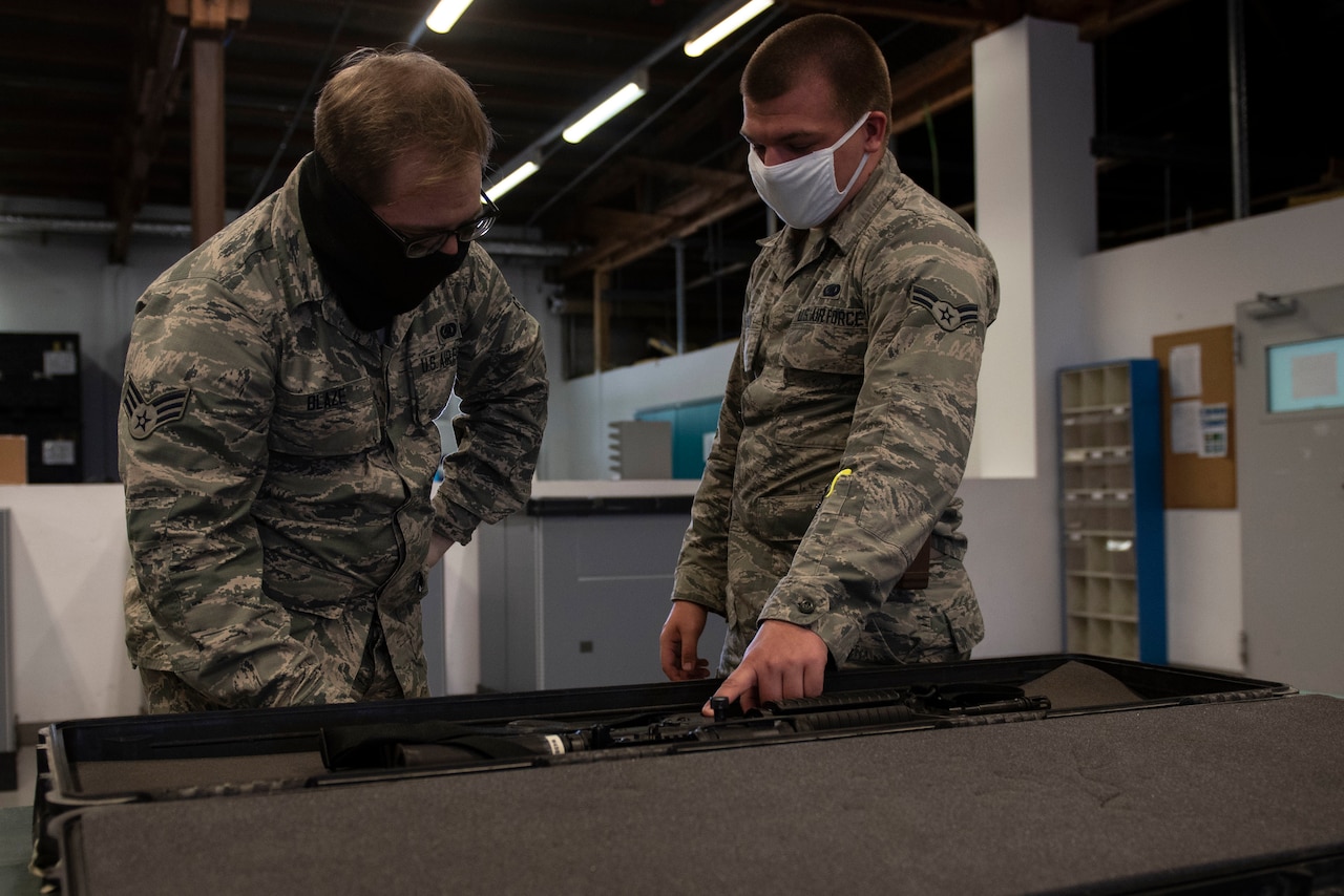 Airmen demonstrating how to issue a weapon.