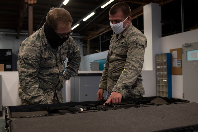 Airmen demonstrating how to issue a weapon.