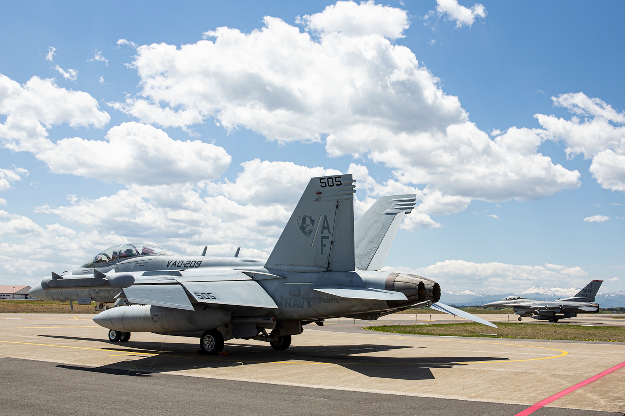 An EA-18G Growler from the Star Warriors of VAQ-209 sits ready to fly next to an F-16CM from the 13th Fighter Squadron at Misawa Air Base, Japan. VAQ-209 and the 13th & 14th Fighter Squadrons have recently been conducting suppression of enemy air defense training exercises to increase joint readiness and be ready to Fight Tonight! VAQ-209 is the US military's only reserve electronic attack squadron and is currently forward deployed to the INDOPACOM AOR in support of forward presence and stability operations. (U.S. Navy photo by Cmdr. Peter Scheu)
