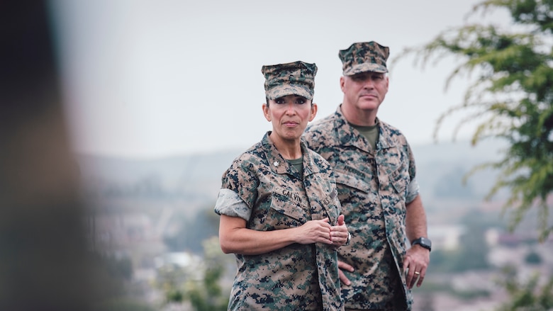 U.S. Marine Corps Lt. Col. Juliet Calvin, left, the commanding officer of 1st Network Battalion, Marine Corps Cyberspace Operations Group, speaks to Marines and civilians during the battalion transfer of authority at Marine Corps Base Camp Pendleton, California, June 4, 2020. 1st Network Bn., the first of six new Marine Corps network units, was created to improve oversight, command, and control of the Marine Corps enterprise network while managing building and local area networks around base. (U.S. Marine Corps photo by Staff Sgt. Donald Holbert)