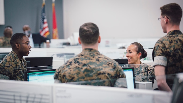 U.S. Marine Corps Lt. Col. Juliet Calvin, second from right, the commanding officer of 1st Network Battalion, Marine Corps Cyberspace Operations Group, speaks to Marines at their workstations during a walkthrough at Marine Corps Base Camp Pendleton, California, June 4, 2020. 1st Network Bn., the first of six new Marine Corps network units, was created to improve oversight, command, and control of the Marine Corps enterprise network while managing building and local area networks around base. (U.S. Marine Corps photo by Staff Sgt. Donald Holbert)