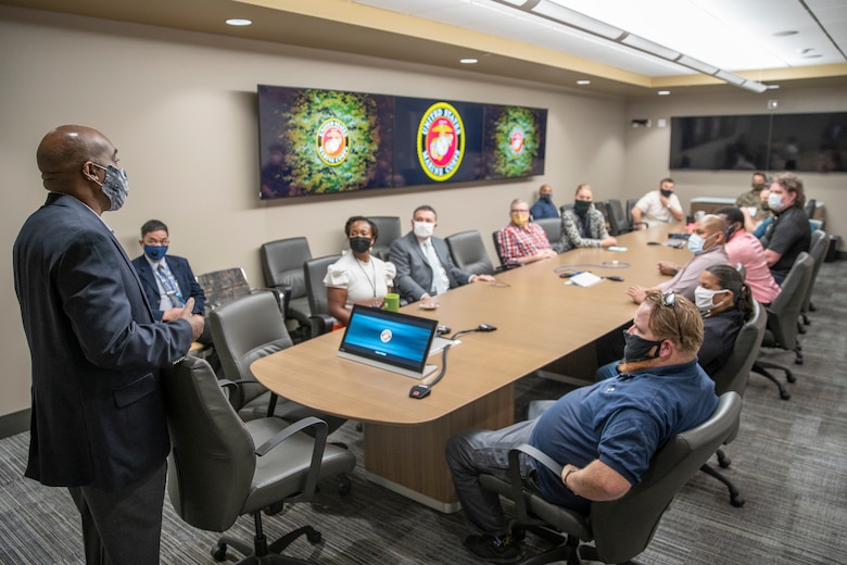 Terence Adams, left, the deputy of 1st Network Battalion, Marine Corps Cyberspace Operations Group, speaks to Marines and civilians during a meeting at Marine Corps Base Camp Pendleton, California, June 4, 2020. 1st Network Bn., the first of six new Marine Corps network units, was created to improve oversight, command, and control of the Marine Corps enterprise network while managing building and local area networks around base. (U.S. Marine Corps photo by Cpl. Dalton S. Swanbeck)