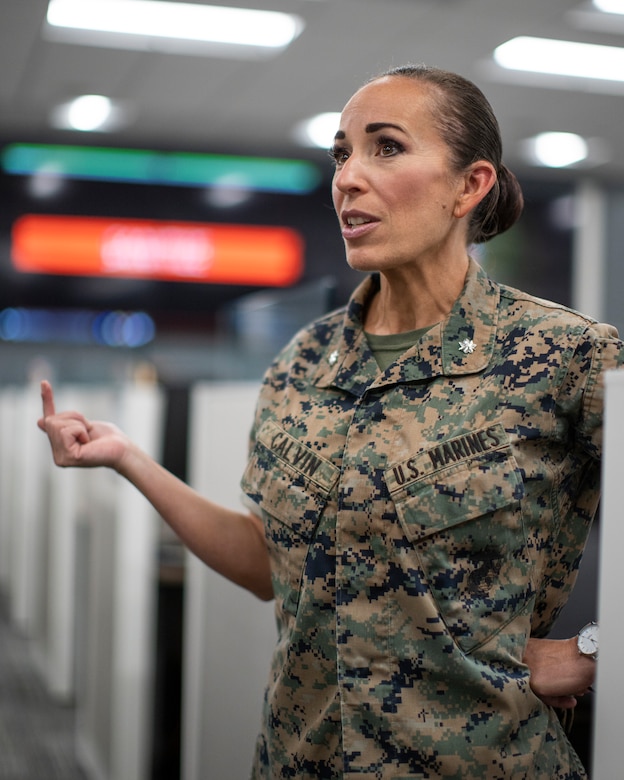 U.S. Marine Corps Lt. Col. Juliet Calvin, the commanding officer of 1st Network Battalion, Marine Corps Cyberspace Operations Group, speaks to Marines at their workstations during a walkthrough at Marine Corps Base Camp Pendleton, California, June 4, 2020. 1st Network Bn., the first of six new Marine Corps network units, was created to improve oversight, command, and control of the Marine Corps enterprise network while managing building and local area networks around base. (U.S. Marine Corps photo by Cpl. Dalton S. Swanbeck)