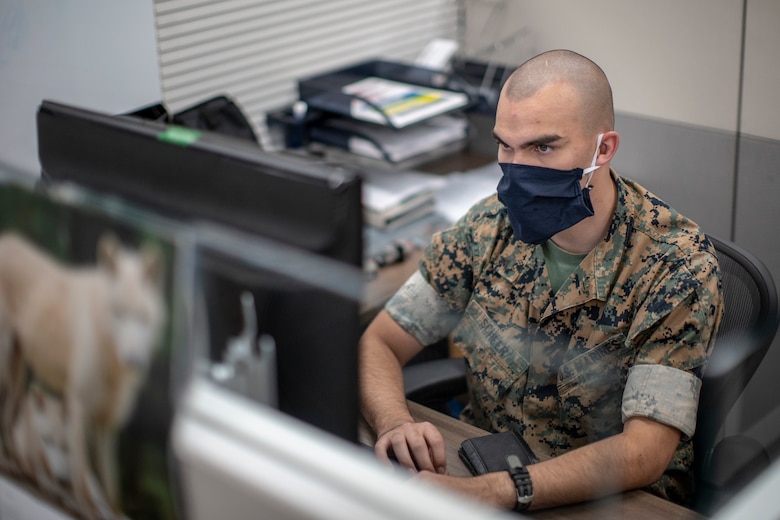 U.S. Marine Corps Lance Cpl. Joshua Scheer, a network administrator with 1st Network Battalion, Marine Corps Cyberspace Operations Group, analyzes network data at his workstation at Marine Corps Base Camp Pendleton, California, June 4, 2020. 1st Network Bn., the first of six new Marine Corps network units, was created to improve oversight, command, and control of the Marine Corps enterprise network while managing building and local area networks around base. (U.S. Marine Corps photo by Cpl. Dalton S. Swanbeck)