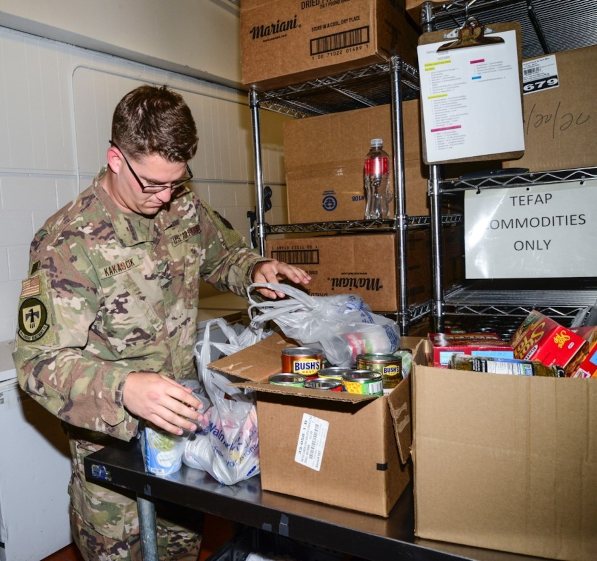Airman unpacks boxes of donations
