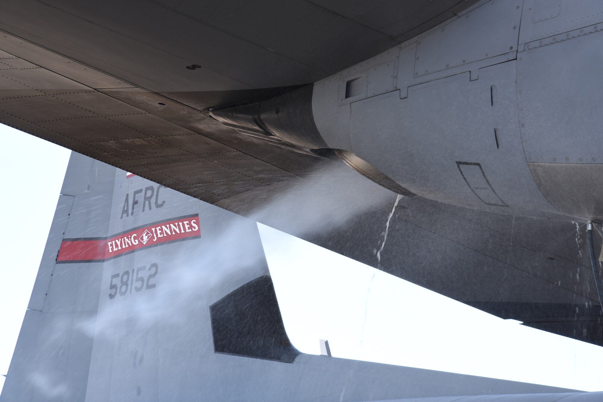 An 815th Airlift Squadron C-130J Super Hercules receives an Engine Compressor Wash before the aircraft goes for a "C" letter inspection in the Isochronal Dock at Keesler Air Force Base, Mississippi May 11, 2020. While completing the ECW, members of the 403rd Maintenance Squadron observe the water and mist that comes out of the engine compartment to ensure the engine is clean prior to inspection. These inspections or letter checks can range from "A" five days basic check, "B" 18 days and more in depth, to "C" 22 days which is the most intrusive inspection; but are necessary to keep the aircraft maintained. (U.S. Air Force photo by Jessica L. Kendziorek)