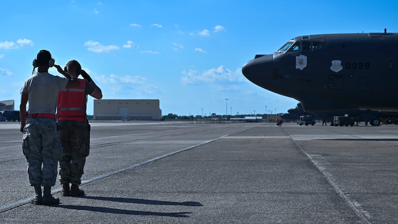 Senior Airman Tyler Burke (left) and Airman 1st Class Ethan Wright (right), both 96th Aircraft Maintenance Unit crew chiefs, salute as a B-52H Stratofortress begins to taxi at Barksdale Air Force Base, La., June 13, 2020. The B-52 was departing for Eielson Air Force Base, Alaska, to integrate and operate in the Indo-Pacific theater. (U.S. Air Force photo by Staff Sgt. Stuart Bright)