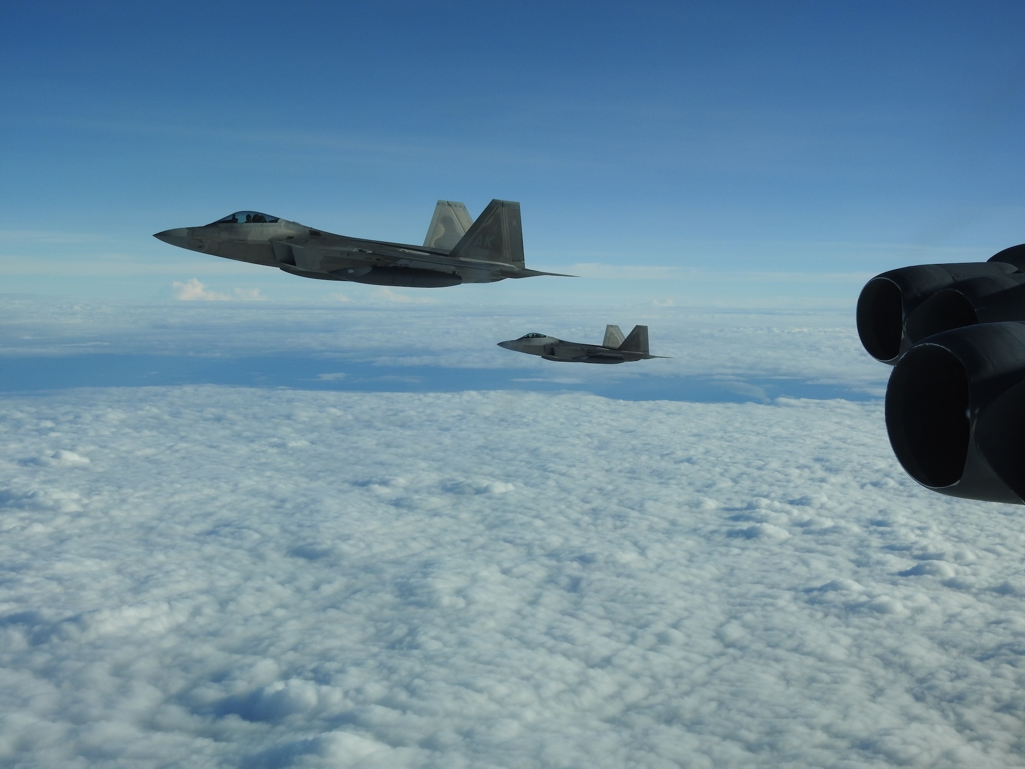 An F-22 Raptor, assigned to Joint Base Elmendorf, Richardson, Alaska, escorts a B-52 Stratofortress during a North American Aerospace Defense Command (NORAD) mission, June 14, 2020. NORAD routinely conducts intercept training in support of its mission to protect the sovereign airspaces of the United States and Canada. (Courtesy Photo)