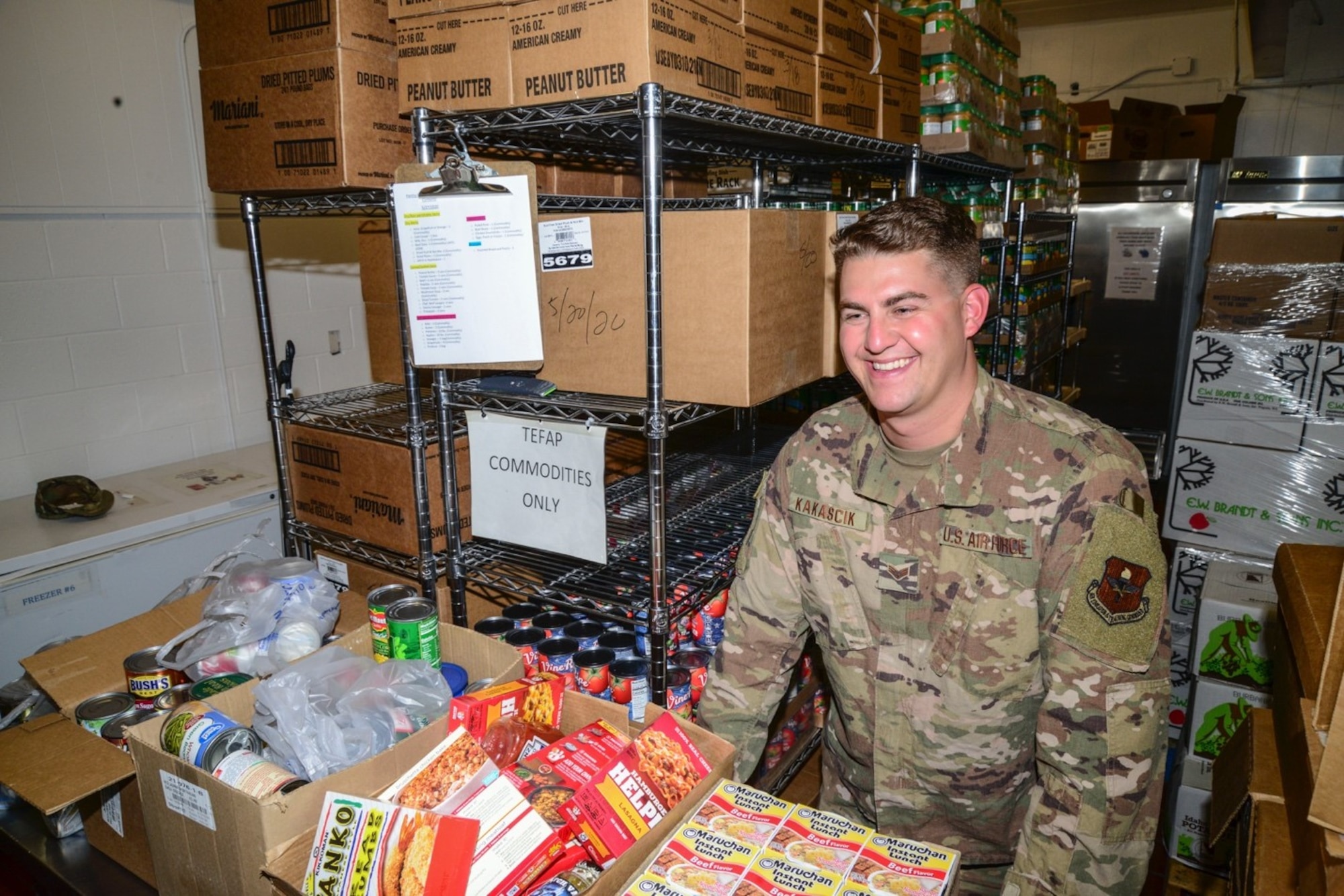 Airman unpacks boxes of donations