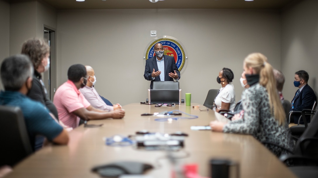 Terence Adams, center, the deputy of 1st Network Battalion, Marine Corps Cyberspace Operations Group, speaks to Marines and civilians during a meeting at Marine Corps Base Camp Pendleton, California, June 4, 2020. 1st Network Bn., the first of six new Marine Corps network units, was created to improve oversight, command, and control of the Marine Corps enterprise network while managing building and local area networks around base. (U.S. Marine Corps photo by Cpl. Dalton S. Swanbeck)