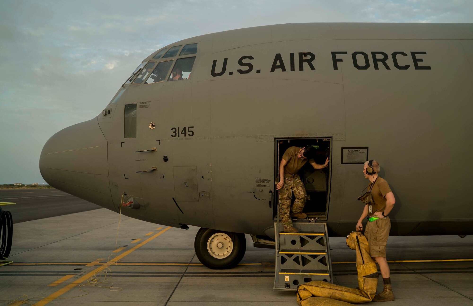 U.S. Air Force Airmen from the 75th Expeditionary Airlift Squadron (EAS) perform pre-flight checks before takeoff on a C-130J Super Hercules at Camp Lemonnier, Djibouti, June 6, 2020. The 75th EAS provides strategic Airlift capabilities across the Combined Joint Task Force - Horn of Africa (CJTF-HOA) area of responsibility. (U.S. Air Force photo by Staff Sgt. Shawn White)