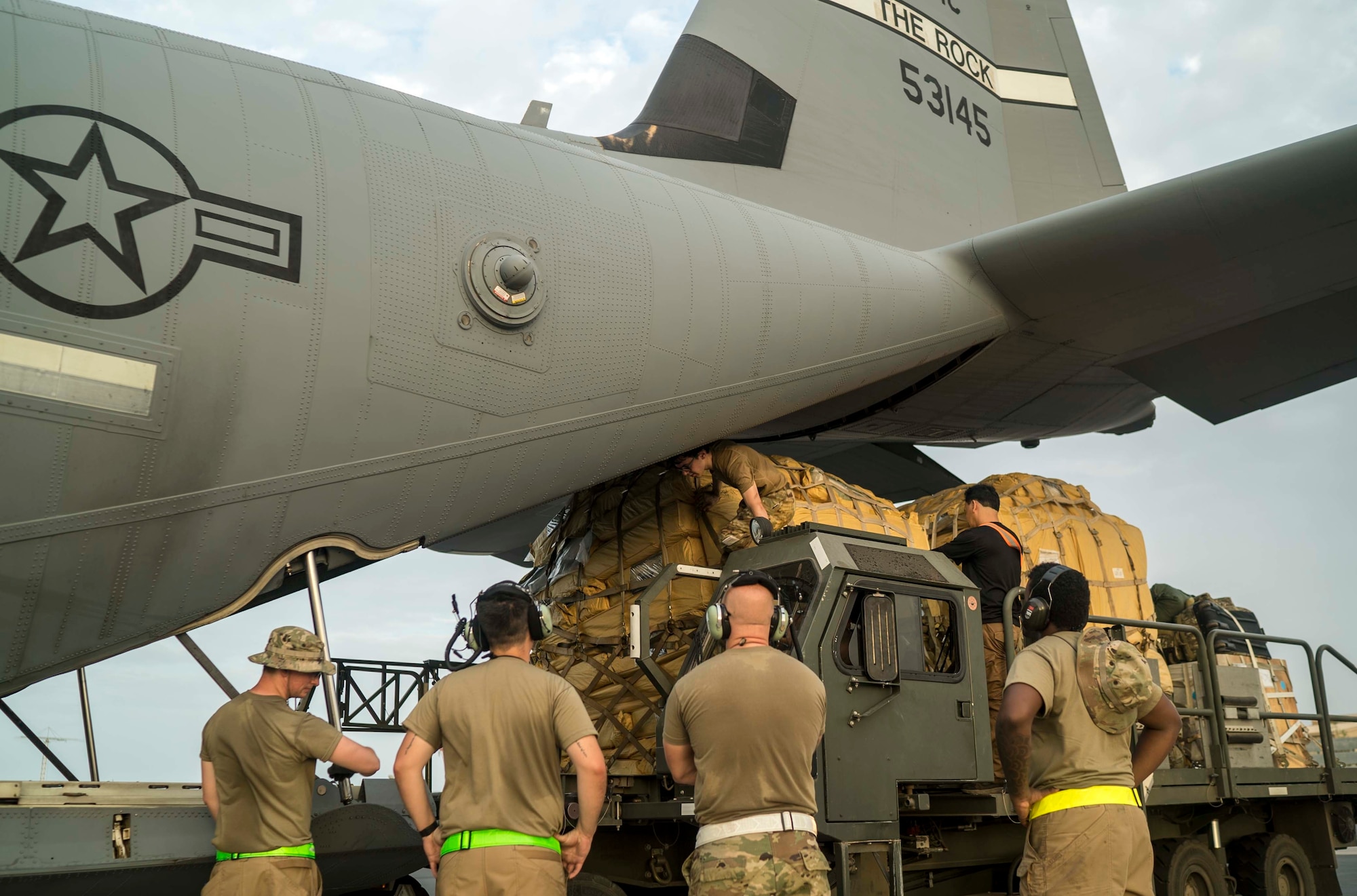 U.S. Air Force Airmen from the 75th Expeditionary Airlift Squadron (EAS) prepare to load cargo onto a C-130J Super Hercules at Camp Lemonnier, Djibouti, June 6, 2020. The 75th EAS provides strategic Airlift capabilities across the Combined Joint Task Force - Horn of Africa (CJTF-HOA) area of responsibility. (U.S. Air Force photo by Staff Sgt. Shawn White)