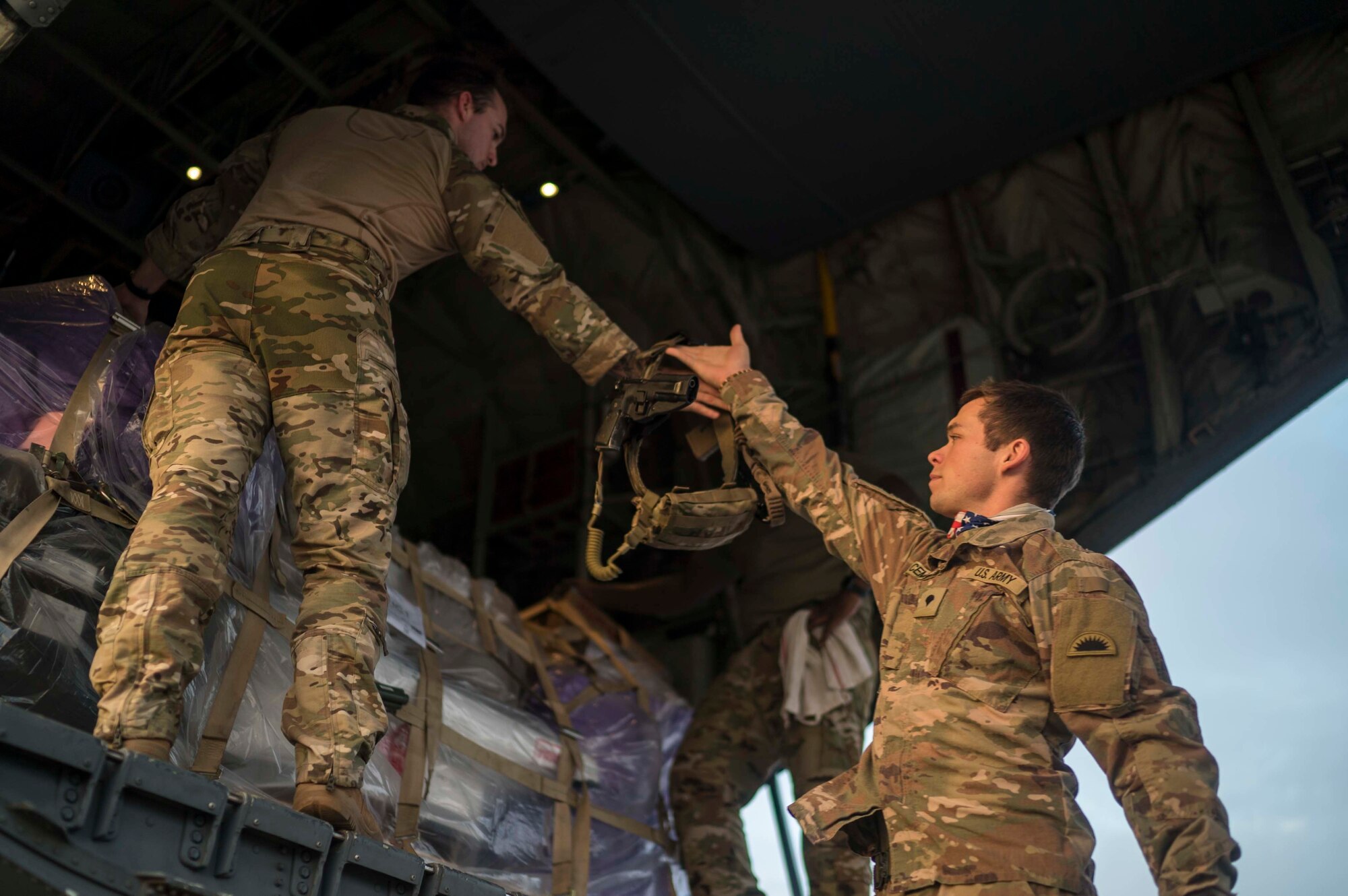 U.S. Army Spc. Michael Lesly (left) and Spc. Kameron Cempa both assigned to Site Security Team Task Force Guardian, 1st Battalion, 186th Infantry Brigade Combat Team infantrymen, prepare to board a C-130J Super Hercules from the 75th Expeditionary Airlift Squadron (EAS) at Camp Lemonnier, Djibouti, June 6, 2020. The 75th EAS provides strategic Airlift capabilities across the Combined Joint Task Force - Horn of Africa (CJTF-HOA) area of responsibility. (U.S. Air Force photo by Staff Sgt. Shawn White)