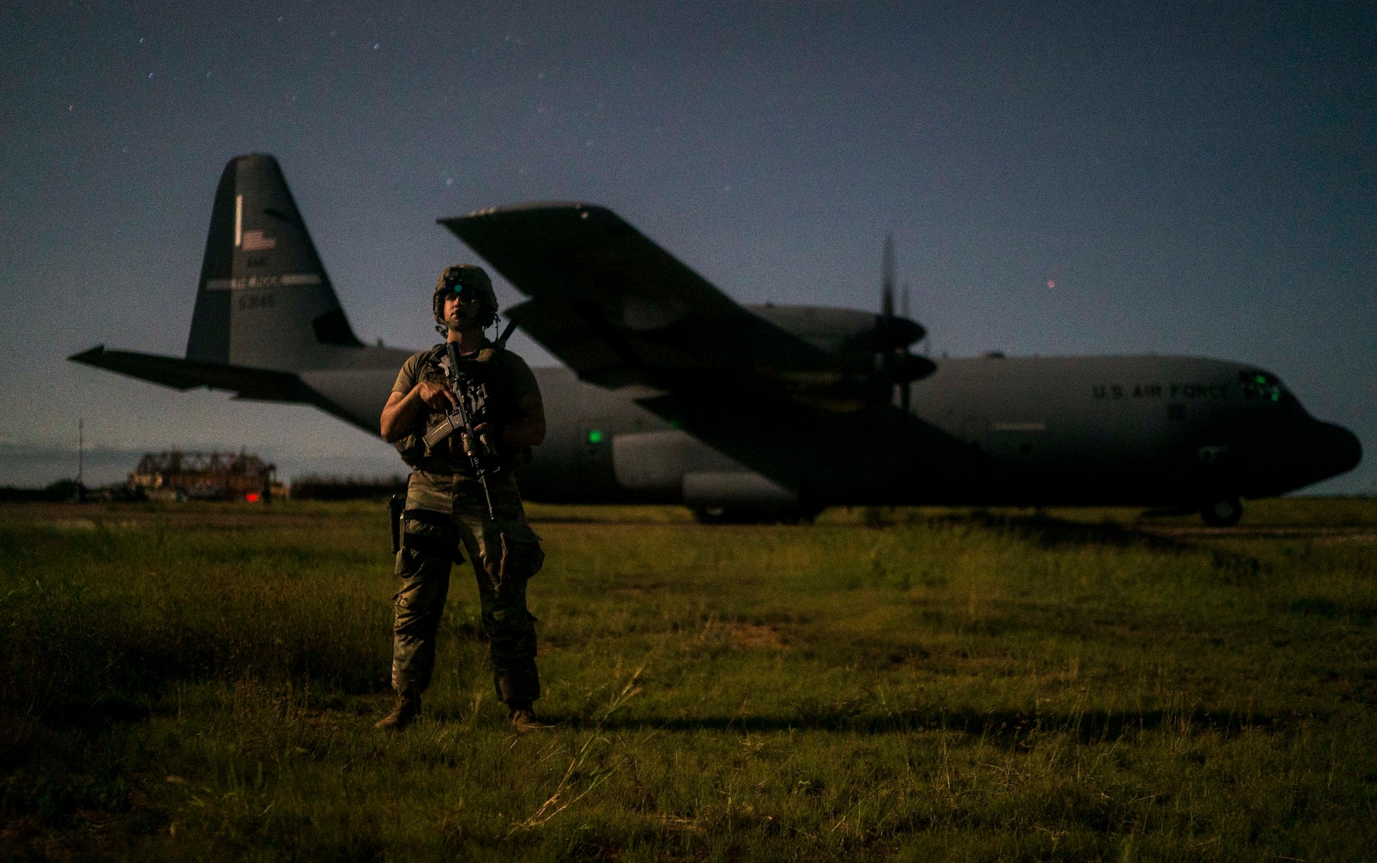 A U.S. Army Spc. Trevor Archa, Site Security Team Task Force Guardian, 1st Battalion, 186th Infantry Brigade Combat Team combat medic, provides security for a C-130J Super Hercules from the 75th Expeditionary Airlift Squadron (EAS) in Somalia, June 6, 2020. The 75th EAS provides strategic Airlift capabilities across the Combined Joint Task Force - Horn of Africa (CJTF-HOA) area of responsibility. (U.S. Air Force photo by Staff Sgt. Shawn White)
