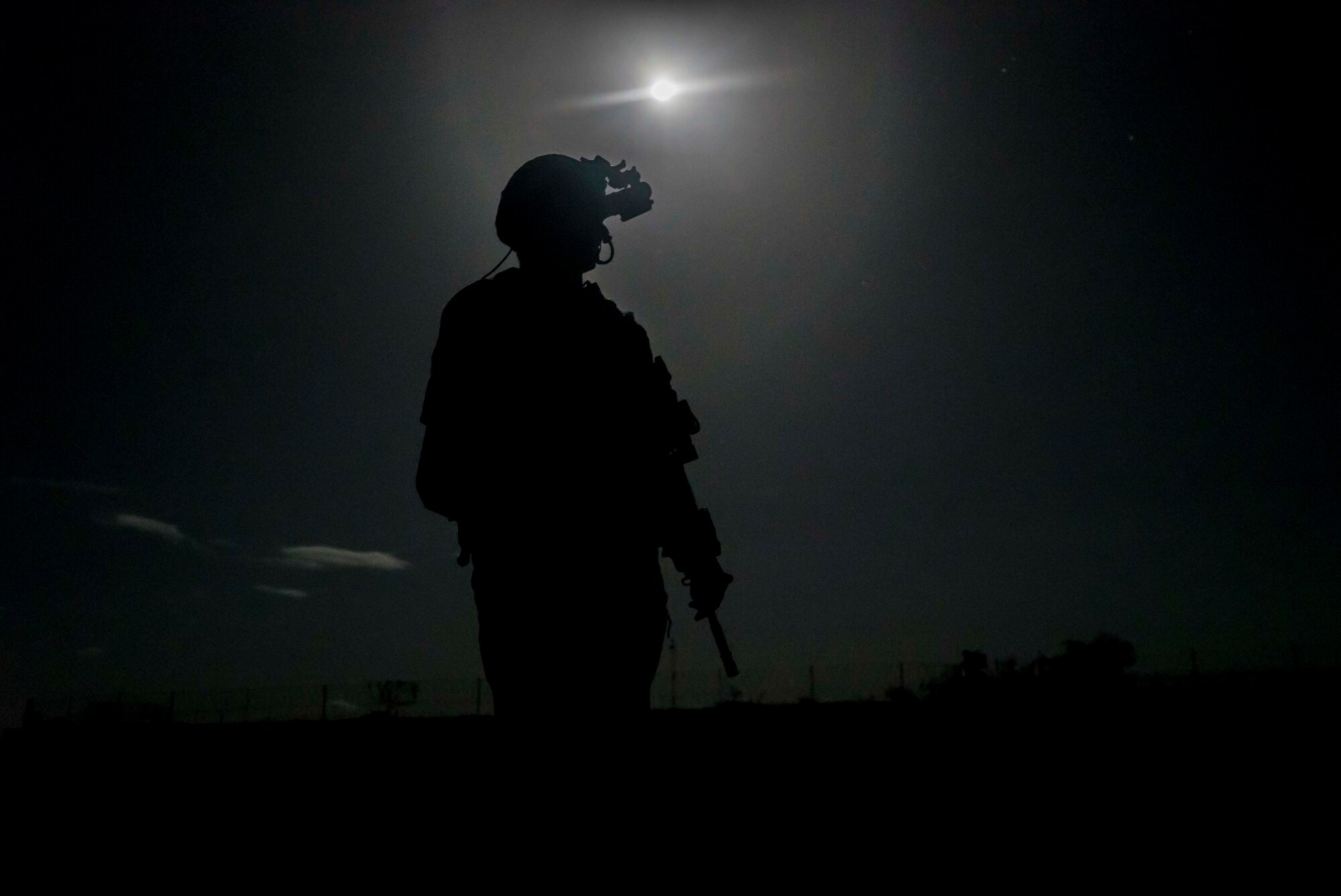 A U.S. Army soldier assigned to Site Security Team Task Force Guardian, 1st Battalion, 186th Infantry Brigade Combat Team, provides security for a C-130J Super Hercules from the 75th Expeditionary Airlift Squadron (EAS) in Somalia, June 6, 2020. The 75th EAS provides strategic Airlift capabilities across the Combined Joint Task Force - Horn of Africa (CJTF-HOA) area of responsibility. (U.S. Air Force photo by Staff Sgt. Shawn White)