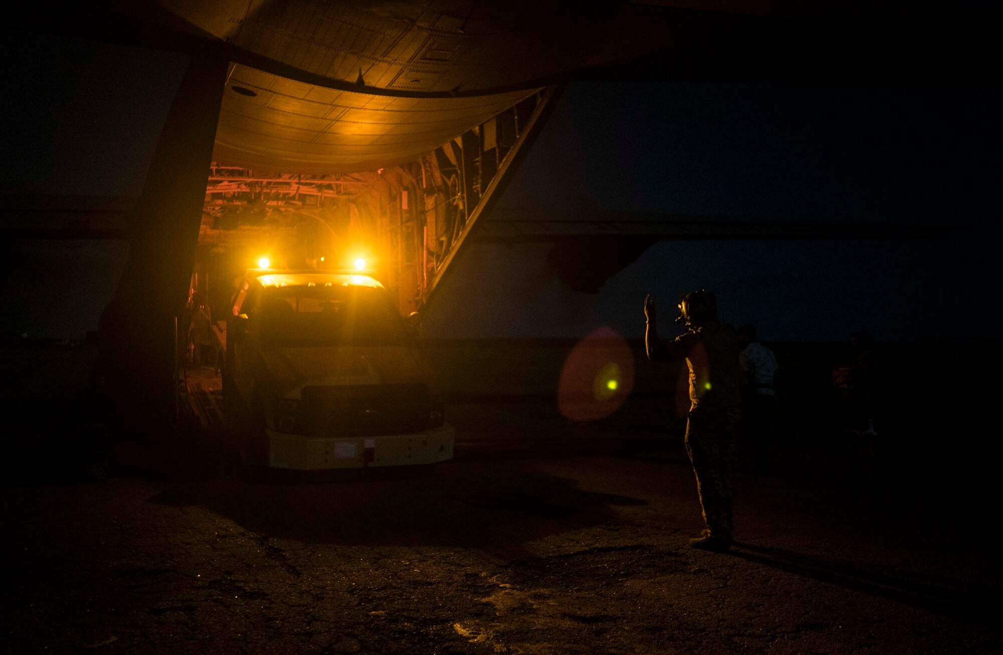 U.S. Air Force Staff Sgt. Anthony Powell, 75th Expeditionary Airlift Squadron (EAS) loadmaster instructor, offloads cargo from a C-130J Super Hercules in Somalia, June 6, 2020. The 75th EAS provides strategic Airlift capabilities across the Combined Joint Task Force - Horn of Africa (CJTF-HOA) area of responsibility. (U.S. Air Force photo by Staff Sgt. Shawn White)