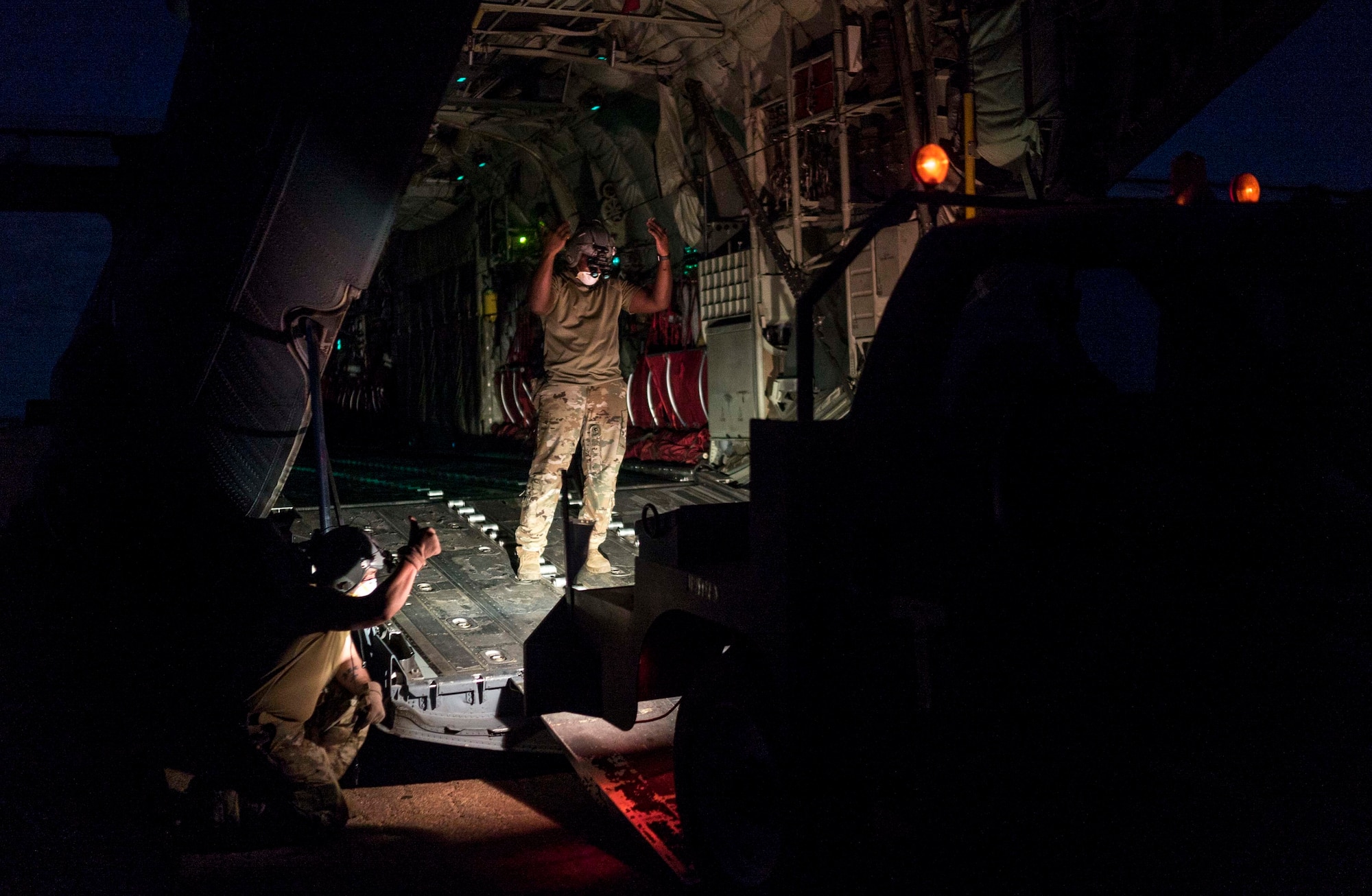 U.S. Air Force loadmasters from the 75th Expeditionary Airlift Squadron (EAS) load cargo onto a C-130J Super Hercules in Somalia, June 6, 2020. The 75th EAS provides strategic Airlift capabilities across the Combined Joint Task Force - Horn of Africa (CJTF-HOA) area of responsibility. (U.S. Air Force photo by Staff Sgt. Shawn White)