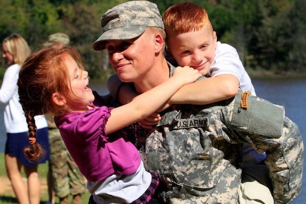 Female Army officer and family