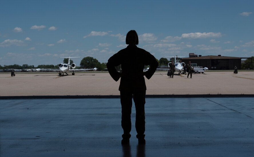 U.S. Air Force officer stands in an aircraft hangar