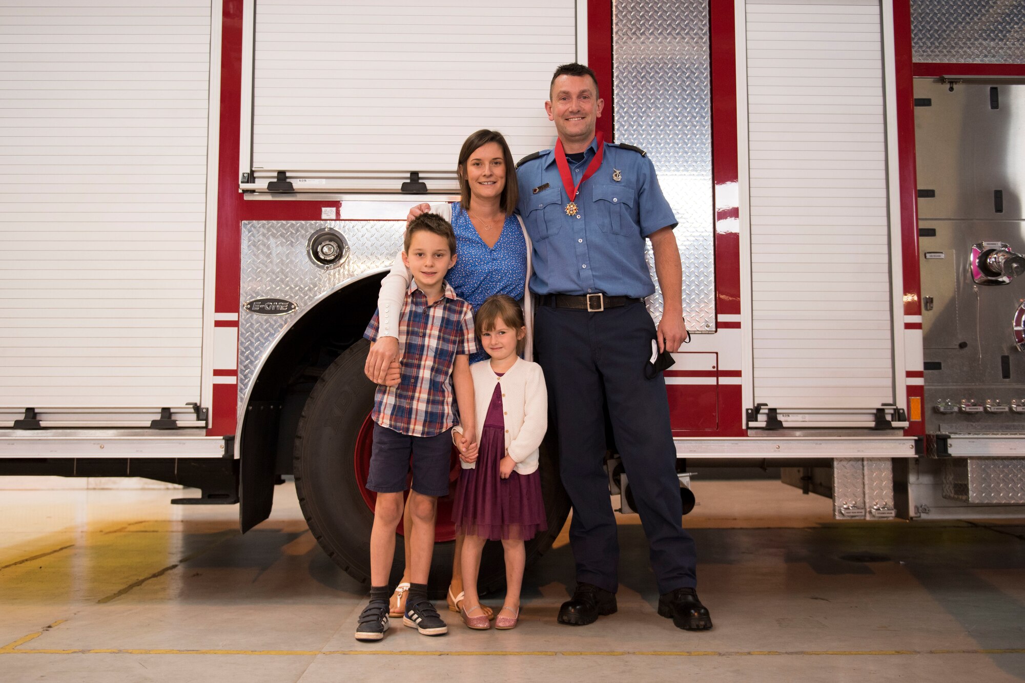 Lee Joyce, 423rd Civil Engineer Squadron lead firefighter, is awarded the Fire Department’s Life Saving Medal at RAF Alconbury, England, June 16, 2020, for saving his daughter’s life. Lee utilized his firefighter training to assist his four-year-old daughter when she was chocking on a chocolate egg May 16, 2020. (U.S. Air Force photo by Airman 1st Class Jennifer Zima)