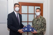 Shipyard Commander, Capt. Kai Torkelson presents a U.S. Flag to Sturtevant Funeral Home Representative Robie Gardner. The Norfolk Naval Shipyard Veteran Employee Readiness Group (VET-ERG) presented 113 U.S. Flags to Sturtevant June 12 in honor of Flag Day to be used in their Retire the Flag Program.