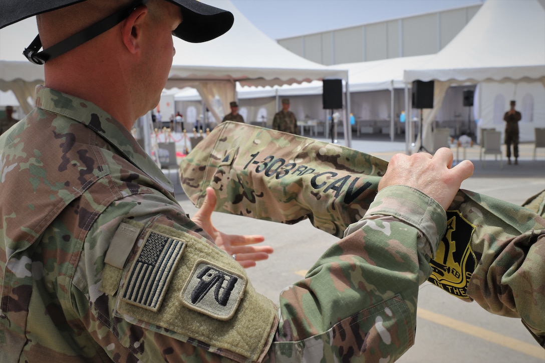 Cmd. Sgt. Maj. John Hurt of the 1st Squadron, 303rd Cavalry Regiment (1-303 CAV), cases his unit's colors during the transfer of authority ceremony Thursday. The 1-303 CAV completed their mission with the Jordan Operational Engagement Program, which is one of the largest training programs funded by Title 10, U.S. Code Section 333, and consists of 14-week training cycles between the U.S. Army and the Jordan Armed Forces.