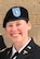 white female in black dress coat, white shirt and black neck tab and a black beret with blue flash with white stars and gold bar.