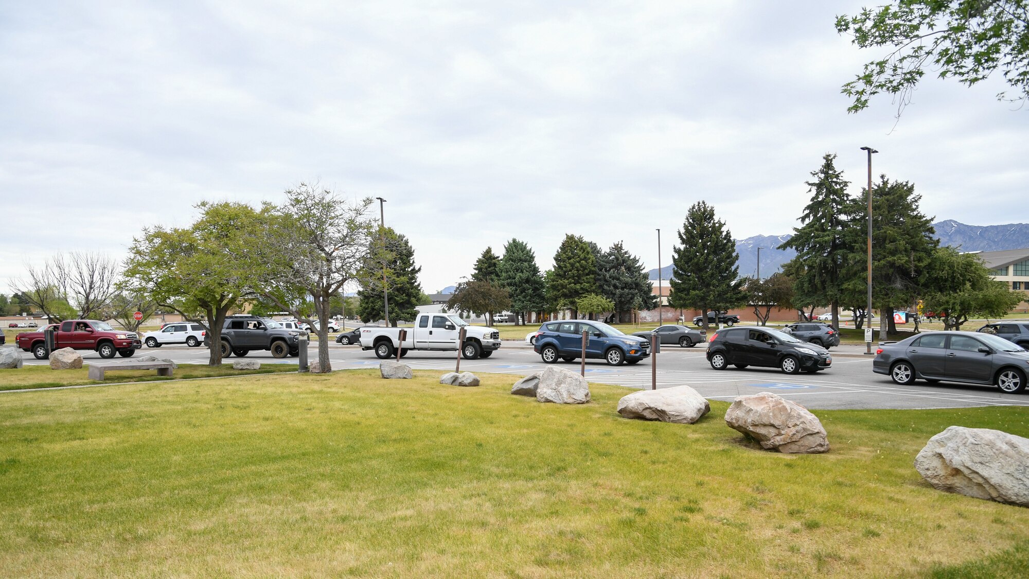 Airmen wait in their cars for a drive-up medical screening and COVID-19 testing.