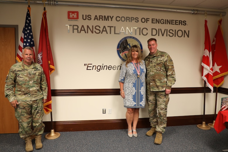 Lt. Gen. Todd T. Semonite, the 54th Chief of Engineers and Commanding General of the U.S. Army Corps of Engineers (left), presents Sally Beck with the Meritorious Public Service Medal. The award was given to Sally for all the work she did supporting families across the Army – specifically the men and women assigned to the Transatlantic Division during the command of her spouse, Col. (P) Chris Beck (right). Due to COVID-19 restrictions, the award was presented while practicing social distancing.