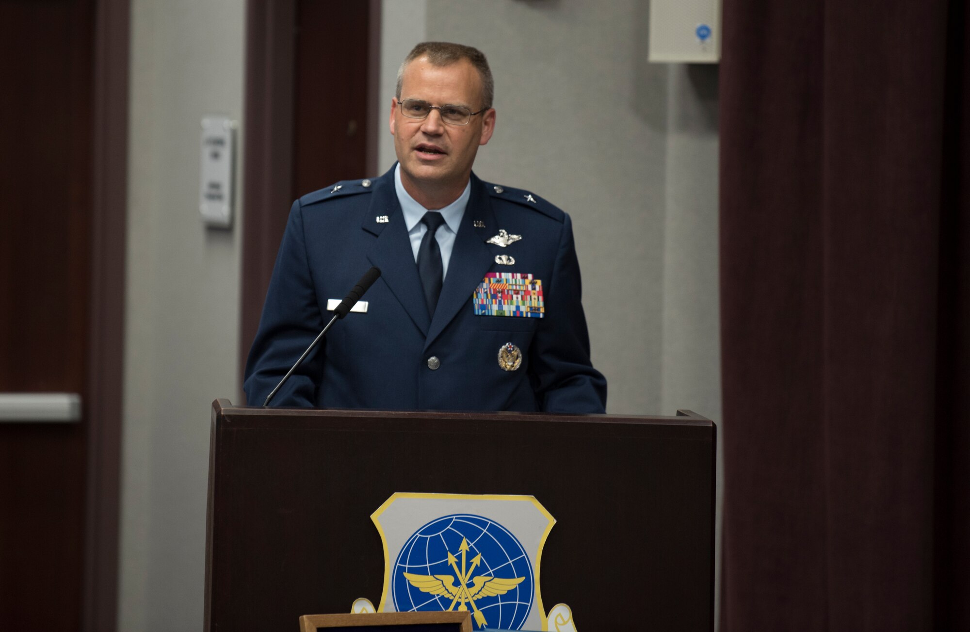 Brig. Gen. Daniel A. DeVoe speaks to the audience after taking command of the 618th Air Operations Center, June 12, at Scott Air Force Base, Ill. The 618th AOC is responsible for operational planning, tasking, executing and assessing a fleet of approximately 1,100 aircraft in support of combat delivery and strategic airlift, air refueling and aeromedical operations around the world. (U.S. Air Force photo by Senior Airman Soloman Cook)