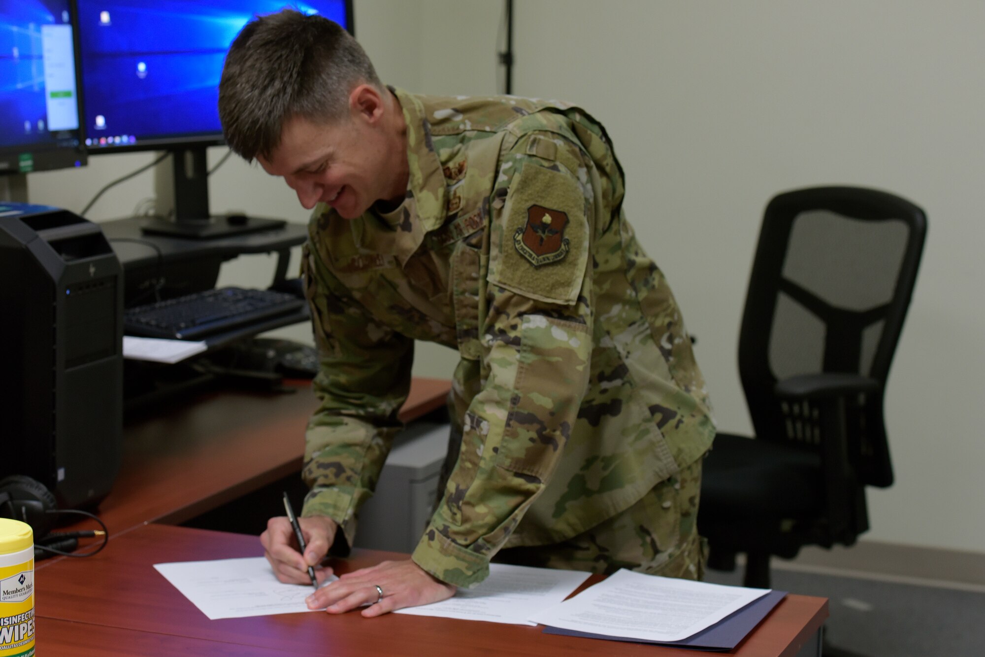 U.S. Air Force Col. Thomas Coakley, 17th Training Group commander, physically signs a Memorandum of Understanding, which creates the Center for Teaching and Learning Excellence for shared professional development between the San Angelo community and members of Goodfellow, during a video call conference in the Brandenburg Hall on Goodfellow Air Force Base, Texas, June 11, 2020. Per the National Defense Strategy, the facility’s development was a multi-level collaboration to build lifelong learners. (U.S. Air Force photo by Senior Airman Zachary Chapman)