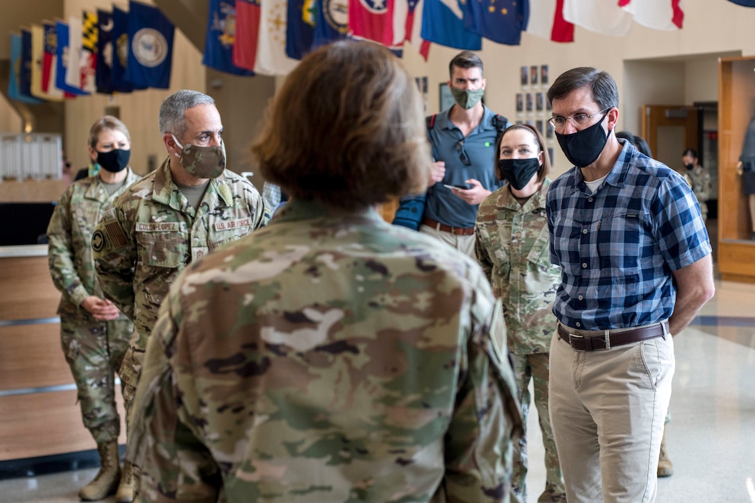 Defense Secretary Dr. Mark T. Esper and Senior Enlisted Advisor to the Chairman Ramón "CZ" Colón-López talk to airmen while wearing masks.