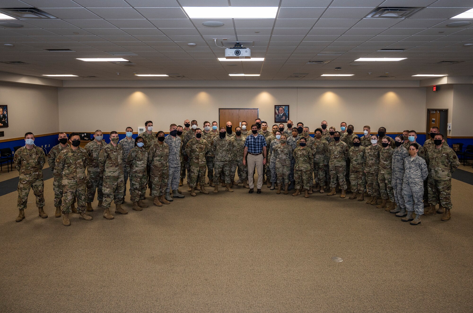 U.S. Secretary of Defense Dr. Mark T. Esper poses for a group photo with JBSA airmen after administering the oath of enlistment during his visit June 16, 2020, at Joint Base San Antonio-Lackland, Texas. Esper met with AETC leaders to see firsthand how Basic Military Training is fighting through COVID-19 with health protection measures in place and adapting operations to current Centers for Disease Control and Prevention Guidance. The visit also allowed him to witness how a citizen becomes an Airman during COVID-19.