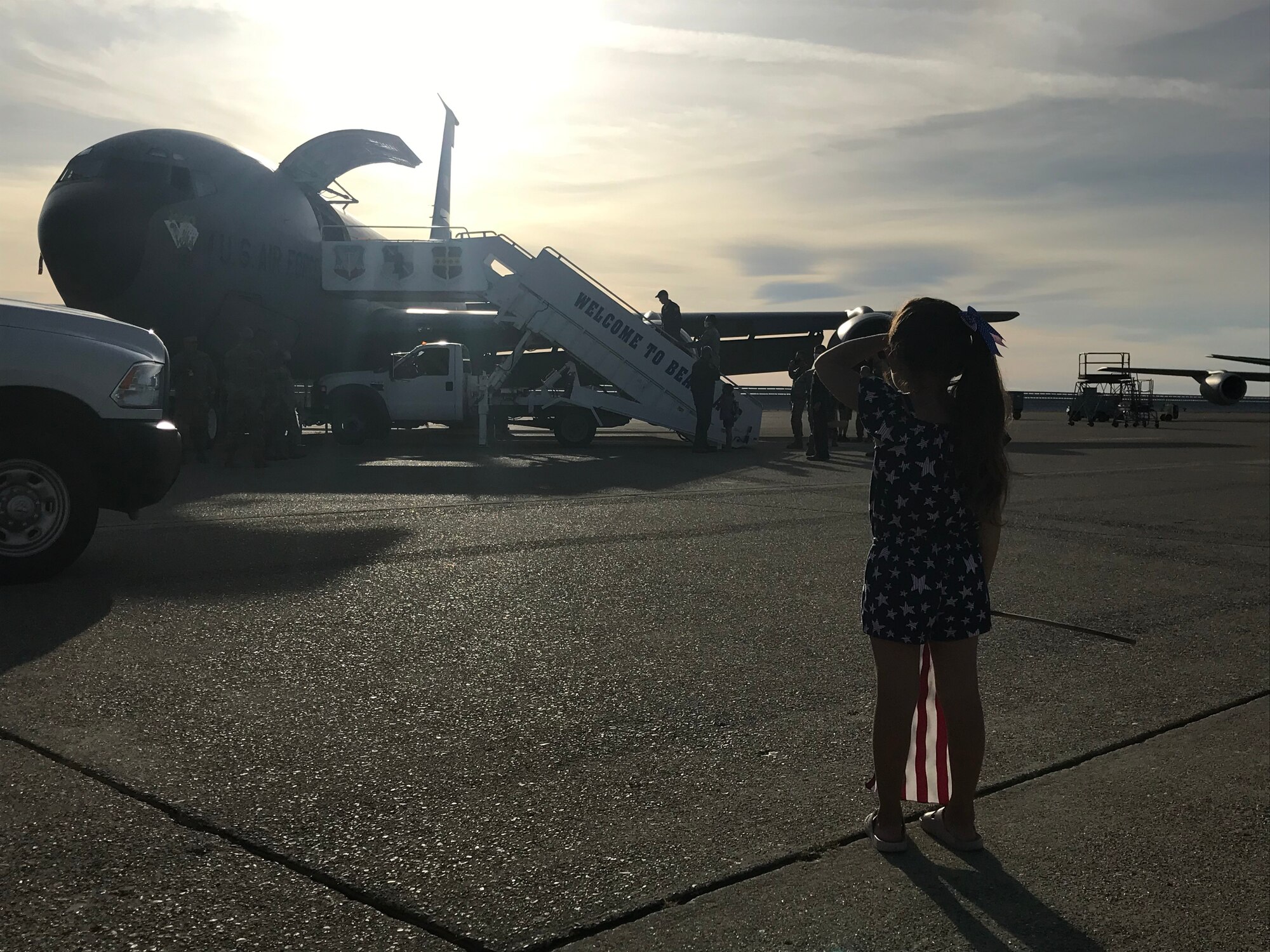 A young girl looks toward a KC-135 Stratotanker as she waits for her father June 14, 2020, at Beale Air Force Base, California.